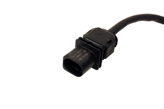 Black automotive sensor with cable on a white background