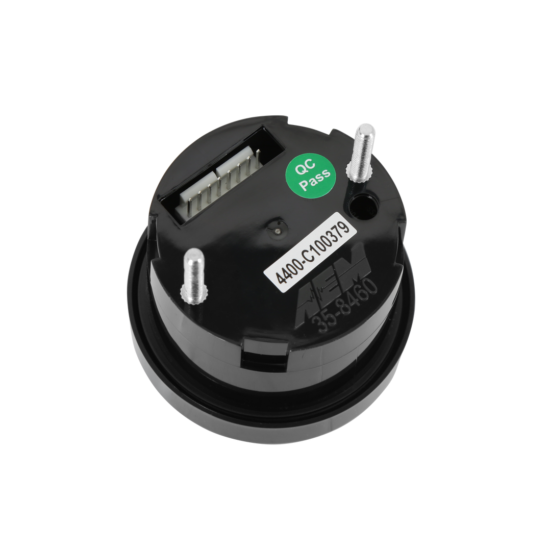 A black circular electronic component with three silver metal pins, a white label, a green &