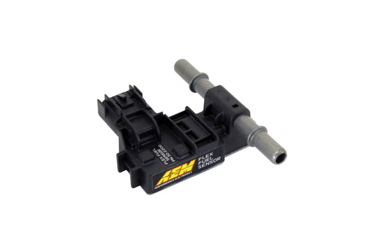 Black ignition coil with yellow branding on a white background