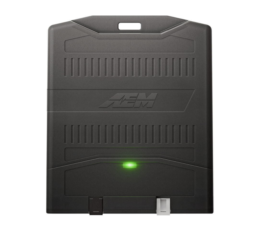 Black electronic device with a green light on a white background