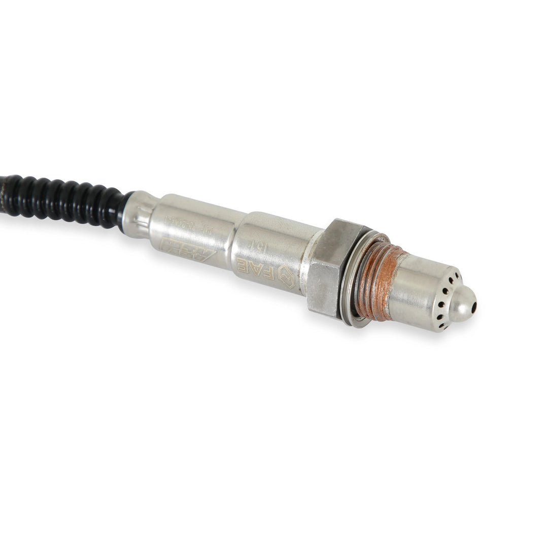 Metallic sensor with a black cable on a white background