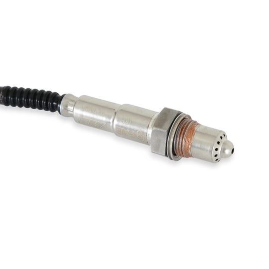 Metallic sensor with a black cable on a white background